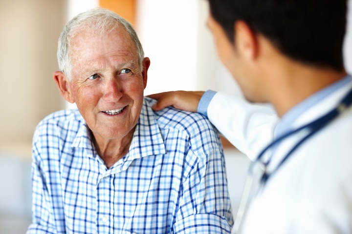 Portrait of senior man listening to medical professional